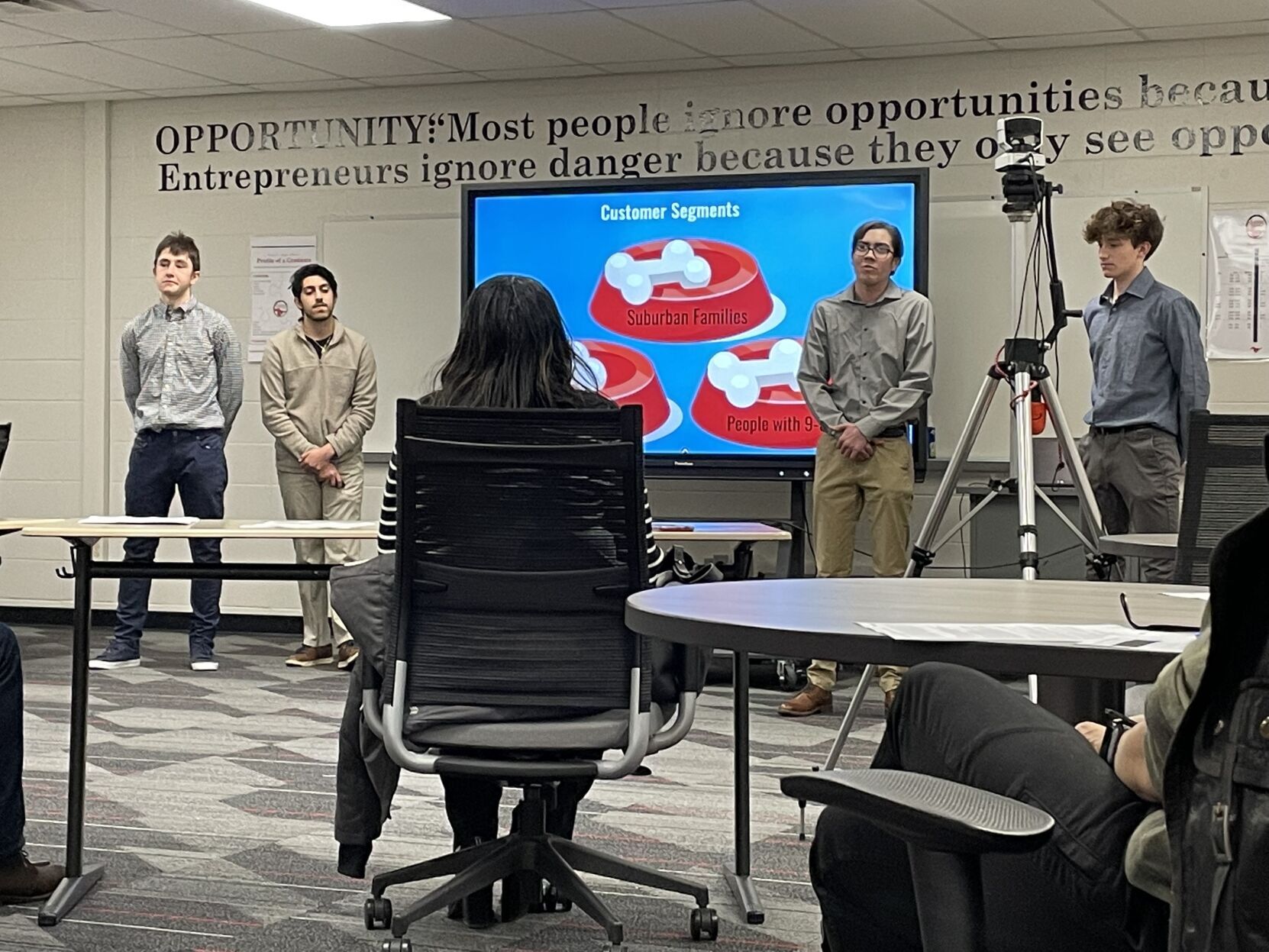 Students present their pitches in front of a group of judges